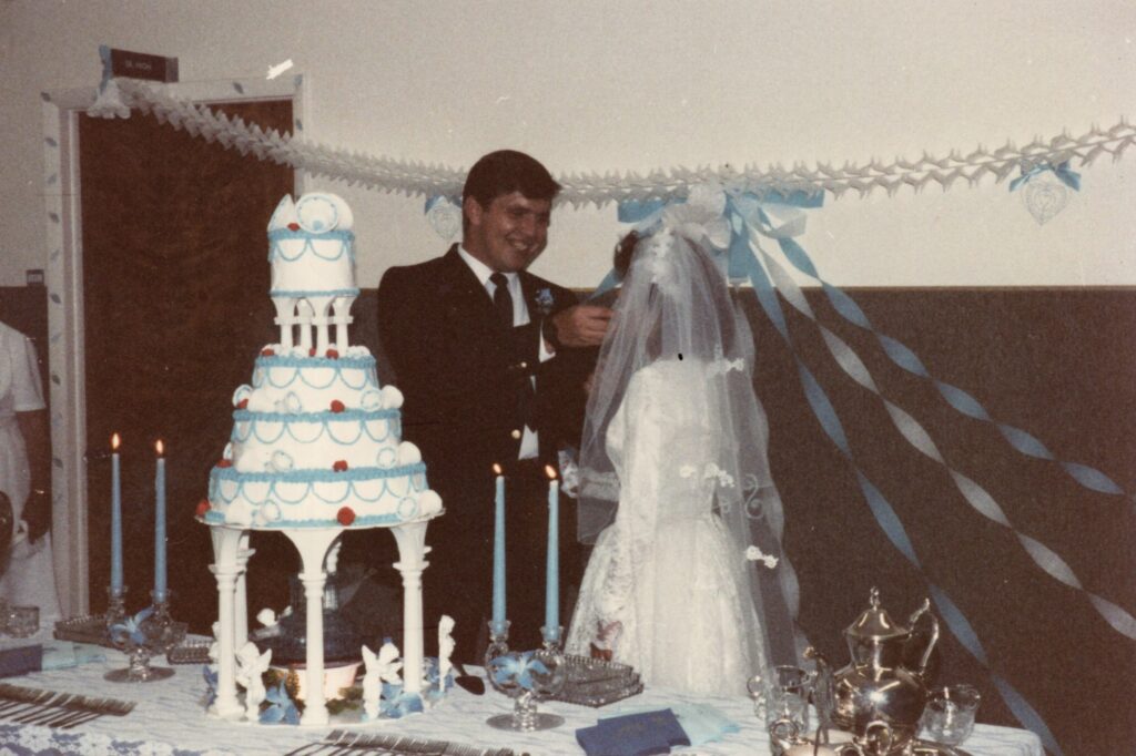 Paul giving a bite of cake to his bride.